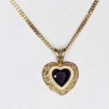 A 9ct yellow gold handmade heart shaped stone with a rubover setting with a carved surround. The