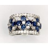 An Platinum Sapphire and diamond flower style dress ring. Approx 2.76cts Sapphire weight total and