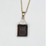 A 9ct yellow gold emerald cut smokey quartz with a diamond pave set into the top section and an inch