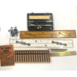 A group of drawing instruments and other technical items, including a Japanese abacus.