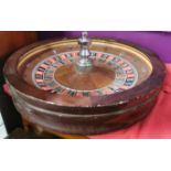 A large mahogany casino roulette wheel together with a case of gambling chips, roulette wheel Dia.