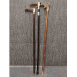 Two antique silver mounted antler handle walking canes, together with a further antler handled