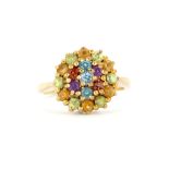 A hallmarked 9ct yellow gold cluster ring set with round cut peridot, amethysts, citrines,