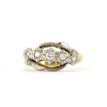 A hallmarked 18ct yellow and white gold ring set with five graduated brilliant cut diamonds, (Q.5)