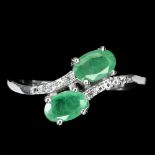 A 925 silver crossover ring set with two oval cut emeralds and white stones, (P).