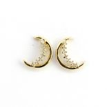 A pair of 9ct yellow gold crescent moon shaped diamond set stud earrings, L. 1cm.