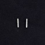 A pair of 18ct white gold diamond set stud earrings, L. 0.7cm.