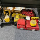A group of vintage Tonka toys and a Japanese battery operated car.