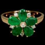 A rose gold on 925 silver flower shaped ring set with pear cut emeralds and white stones, (N).