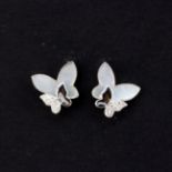 A pair of 9ct white gold mother of pearl and diamond set butterfly shaped stud earrings, L. 0.8mm.