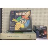 A boxed Subbuteo table cricket, a Simon computer game and an Astro Wars game.