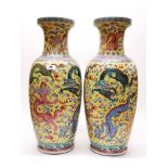 A large pair of Chinese hand enamelled porcelain vases, one large repair to rim, H. 62cm.