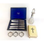 A hallmarked silver mounted perfume bottle with a set of hallmarked silver handled butter knives,