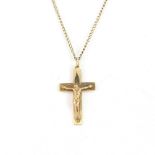 A hallmarked 9ct yellow gold crucifix pendant, L. 3cm, on a 9ct gold chain, L. 41cm.