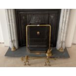 A group of brass fireplace items.