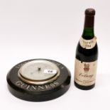 A vintage Guinness advertising barometer, Dia. 21cm, together with a 1964 half bottle of Volnay