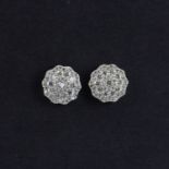 A pair of 18ct white gold diamond set cluster earrings, Dia. 1.1cm, 1ct overall.