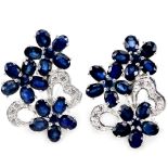 A pair of 925 silver flower shaped earrings set with oval cut sapphires and white stones, L. 2.4cm.