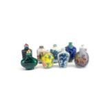 A group of nine mixed porcelain and glass Chinese snuff bottles, tallest 8cm.