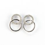 A pair of 9ct white gold diamond set stud earrings, L. 1.1cm.