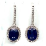 A pair of 925 silver drop earrings set with oval cut sapphires and white stones, L. 2.4cm.