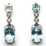 A pair of 925 silver drop earrings set with oval cut blue topaz and white stones, L. 2.1cm.
