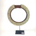 A beautiful gallery mounted Polynesian cowrie shell collar, H. 40cm.