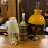 A 1970's stoneware lamp base, two onyx table lamps and a brass oil lamp.