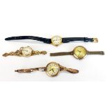 A group of four 9ct gold wristwatches.