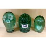 Three large early English bottle glass dump paperweights, largest 14cm.