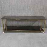 A 1970's gilt brass and smoked glass coffee table, 127 x 38 x 46cm.