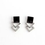 A pair of 9ct white gold onyx and diamond set stud earrings, L. 1cm.