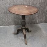 A Georgian oak tilt top pedestal table, H. 70cm.