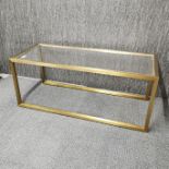 A 1970's brushed brass and glass coffee table, 110 x 45 x 45cm.