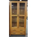 A modern light oak display cabinet with glass shelves, 190 x 92 x 44cm.