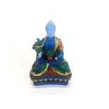 An interesting Sino-Tibetan hand painted blue glass figure of the seated Buddha, H. 12cm.