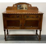 A 1920's carved oak mirror backed sideboard, W. 120cm, H. 120cm.