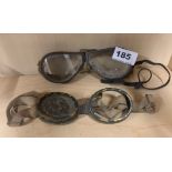 Two pairs of early goggles, smaller pair incomplete.