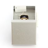 A boxed Calvin Klein yellow metal leather set ring, (M).