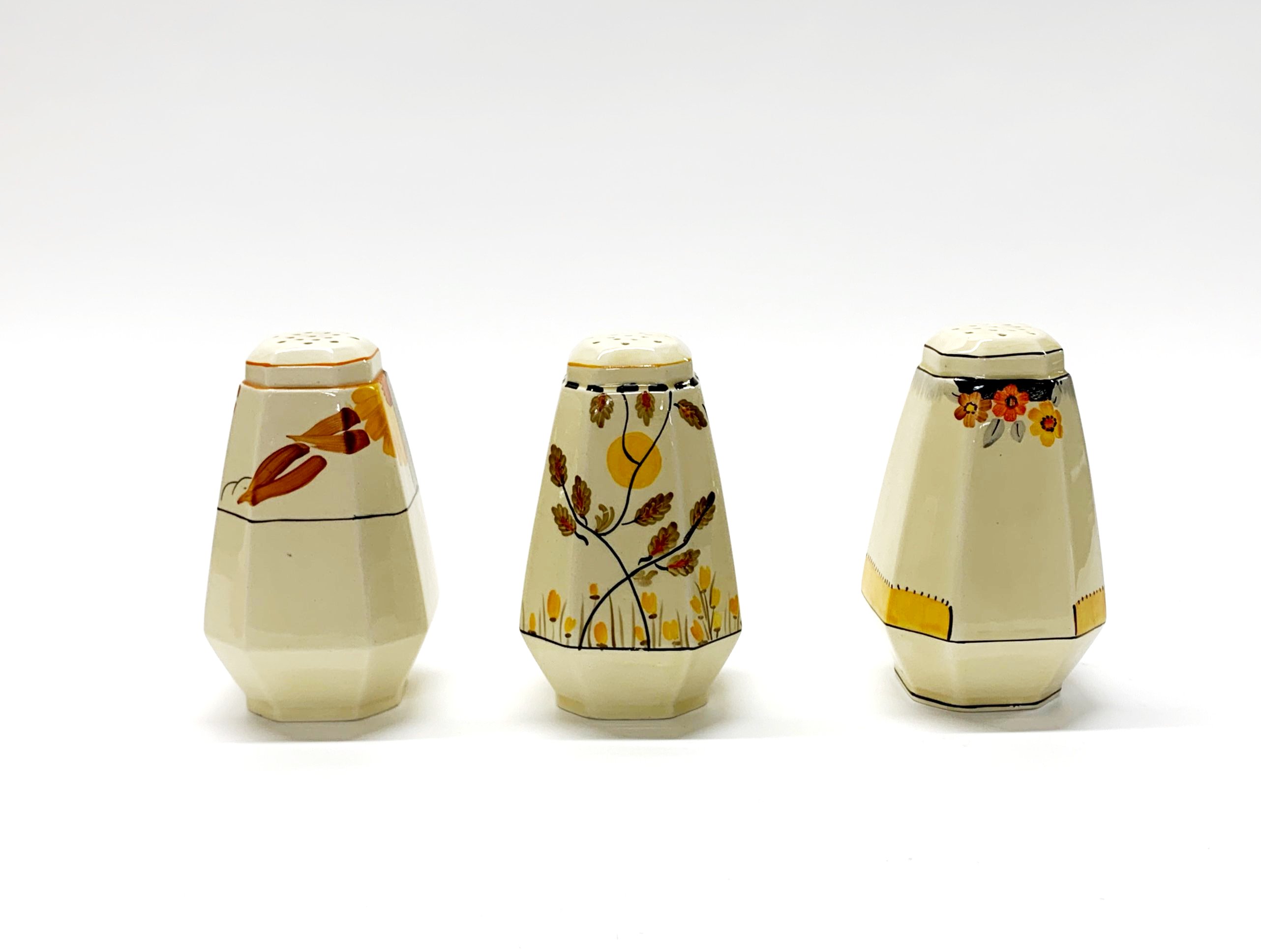 A group of Clarice Cliff, Crown Devon and other Art Deco sugar shakers, H. 12cm. - Image 2 of 3