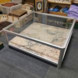 An aluminium and marble topped coffee table with a plate glass topper, 103 x 103 x 42cm.