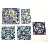 A group of five early Persian hand painted ceramic tiles, largest 21 x 21cm.