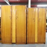 A pair of mahogany and birds eye maple veneered wardrobes, together with a matching dressing table