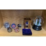 A group of paperweights and other glassware.