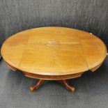 A 19th century tilt top and hinged extendable oval mahogany dining table on column pedestal with