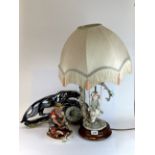 A G.Armani figural table lamp, with a 1950's ceramic clock and a Capo Di Monte porcelain figure.