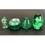 Four early English bottle glass dump paperweights, tallest H. 9cm.