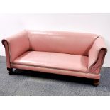 An early 20th century child's drop-end couch re-upholstered in leather, 125 x 65cm.