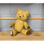 A vintage articulated teddy bear with musical movement, currently not working, H. 45cm.