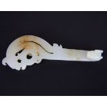 A Chinese white and rustic jade archaic style shoulder buckle with dragon head hook, L. 13cm.